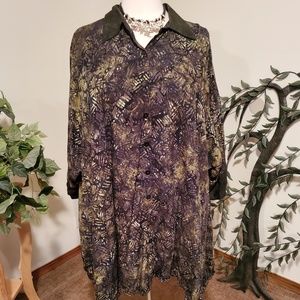 Shades of green, white and black adorn this blouse